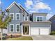 Two-story house with gray siding, white trim, and a two-car garage at 711 Bridgeview Dr, Holly Springs, GA 30115