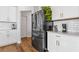 Modern kitchen with black refrigerator and white cabinets at 711 Bridgeview Dr, Holly Springs, GA 30115