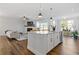 Open concept kitchen with island and white cabinets at 711 Bridgeview Dr, Holly Springs, GA 30115