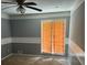 Spacious bedroom with ceiling fan and sliding door at 8374 Carlton Rd, Riverdale, GA 30296