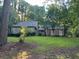 Brick ranch home with mature trees and a large lawn at 8374 Carlton Rd, Riverdale, GA 30296