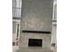 Large stone fireplace with a modern mantel at 8374 Carlton Rd, Riverdale, GA 30296