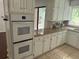 Kitchen with granite countertops and white cabinets at 8374 Carlton Rd, Riverdale, GA 30296