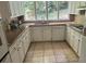U-shaped kitchen with granite counters and tile floor at 8374 Carlton Rd, Riverdale, GA 30296