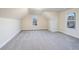 Large bedroom featuring a sloped ceiling, carpet, and two windows at 2490 Melton Common Dr, Dacula, GA 30019