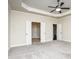 Spacious main bedroom with carpet, tray ceiling, and double doors leading to the en-suite bathroom at 2490 Melton Common Dr, Dacula, GA 30019