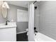 Updated bathroom featuring black hexagon tile, gray subway tile shower, and updated vanity at 649 Ozburn Nw Rd, Atlanta, GA 30318