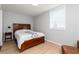 Cozy bedroom features natural light, wood floors, comfortable bed, and tasteful decor at 649 Ozburn Nw Rd, Atlanta, GA 30318