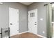 Entryway features modern doors, a sleek rack, and natural light from a nearby window at 649 Ozburn Nw Rd, Atlanta, GA 30318