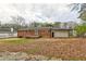 Exterior back view of house with brick and white siding, yard and patio at 649 Ozburn Nw Rd, Atlanta, GA 30318