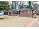 Attractive brick home with an attached garage, cozy front porch, and a walkway at 649 Ozburn Nw Rd, Atlanta, GA 30318