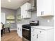 Modern kitchen features stainless steel appliances, quartz countertops, and white cabinets at 649 Ozburn Nw Rd, Atlanta, GA 30318