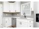 Modern kitchen features white cabinets, stainless steel dishwasher, and quartz countertops at 649 Ozburn Nw Rd, Atlanta, GA 30318