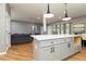 Open concept kitchen with island, pendant lighting, and modern finishes at 649 Ozburn Nw Rd, Atlanta, GA 30318