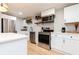 Bright kitchen featuring white cabinetry and stainless steel appliances at 649 Ozburn Nw Rd, Atlanta, GA 30318