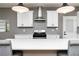 Modern kitchen with stainless steel hood, quartz countertops and updated cabinets at 649 Ozburn Nw Rd, Atlanta, GA 30318