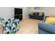Cozy living room featuring comfortable blue seating and a modern entertainment center at 649 Ozburn Nw Rd, Atlanta, GA 30318