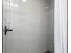 Modern shower with gray tile and matte black shower head at 649 Ozburn Nw Rd, Atlanta, GA 30318