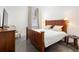 Main bedroom with a wooden bed frame and neutral decor at 10625 Serenbe Ln # 103, Chattahoochee Hills, GA 30268