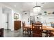 Open concept kitchen with white cabinets and a dining table at 10625 Serenbe Ln # 103, Chattahoochee Hills, GA 30268