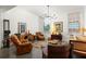 Spacious living room featuring leather armchairs and a large window at 10625 Serenbe Ln # 103, Chattahoochee Hills, GA 30268