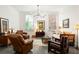 Living room with hardwood floors, comfy seating, and a daybed at 10625 Serenbe Ln # 103, Chattahoochee Hills, GA 30268