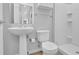 Bathroom featuring white pedestal sink, toilet, and shower at 1412 Peter Haughton Nw Way, Atlanta, GA 30318