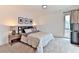 Bright carpeted bedroom features a comfortable bed with warm lamps and view to exterior at 1412 Peter Haughton Nw Way, Atlanta, GA 30318