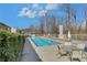 Inviting community pool with tables and seating, surrounded by mature trees and a well-maintained fence at 1412 Peter Haughton Nw Way, Atlanta, GA 30318
