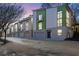 Contemporary townhome with a two-car garage and a vibrant green and white exterior at 1412 Peter Haughton Nw Way, Atlanta, GA 30318