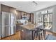 Well-equipped kitchen with stainless steel appliances, granite countertop island, and sleek dark cabinets at 1412 Peter Haughton Nw Way, Atlanta, GA 30318