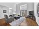 Open concept living room with high ceilings, large windows, and modern furnishings at 1412 Peter Haughton Nw Way, Atlanta, GA 30318