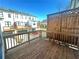 Outdoor deck with wood railings overlooking the backyard and neighboring townhomes at 518 Healy Dr # 68, Cumming, GA 30040
