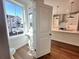 Stylish bathroom with a pedestal sink, modern fixtures, and a view into the contemporary kitchen at 518 Healy Dr # 68, Cumming, GA 30040