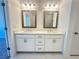 Bathroom features double vanity with mirrors and modern fixtures; marble floors at 518 Healy Dr # 68, Cumming, GA 30040