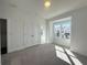 Bright bedroom with carpeted floors, closet, and a large window that lets in natural light at 518 Healy Dr # 68, Cumming, GA 30040