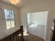 Bright foyer featuring wood floors, staircase, and view into a carpeted room, creating a welcoming entrance at 518 Healy Dr # 68, Cumming, GA 30040
