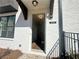 Elegant entryway with white brick facade, black trim, and visible house number creating a welcoming entrance at 518 Healy Dr # 68, Cumming, GA 30040