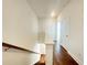 Hallway leads to a second floor with hardwood floors and white walls and railing at 518 Healy Dr # 68, Cumming, GA 30040