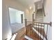 Bright hallway with hardwood floors, view of stairs, and adjacent carpeted room provides spacious flow at 518 Healy Dr # 68, Cumming, GA 30040