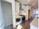Modern kitchen showcasing stainless steel appliances, white cabinetry, and an adjacent pantry for ample storage at 518 Healy Dr # 68, Cumming, GA 30040