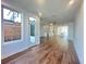 Spacious living room with hardwood floors, large windows, and a glimpse of the modern kitchen at 518 Healy Dr # 68, Cumming, GA 30040