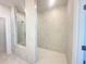 Large walk-in shower with marble surround, glass door, and overhead shower fitting at 518 Healy Dr # 68, Cumming, GA 30040