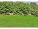 Large grassy backyard with wooden fence and lush trees at 3945 Silverthorn Trce, Cumming, GA 30028