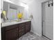 Double vanity bathroom with dark brown cabinets and a large mirror at 3945 Silverthorn Trce, Cumming, GA 30028