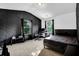 Modern bedroom with dark-themed decor and large windows at 3945 Silverthorn Trce, Cumming, GA 30028