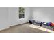 Simple bedroom with a large window and neutral colored walls at 3945 Silverthorn Trce, Cumming, GA 30028
