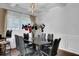 Elegant dining room with a glass table and black chairs at 3945 Silverthorn Trce, Cumming, GA 30028