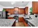 Modern kitchen features granite countertops, stainless steel appliances, and ample cabinetry at 3945 Silverthorn Trce, Cumming, GA 30028
