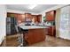 Island kitchen with granite countertops and stainless steel appliances at 3945 Silverthorn Trce, Cumming, GA 30028
